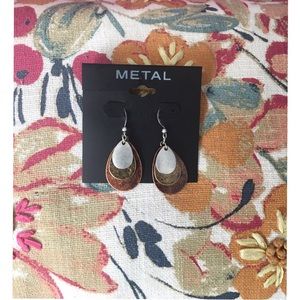 Earrings with contrasting metal pieces.